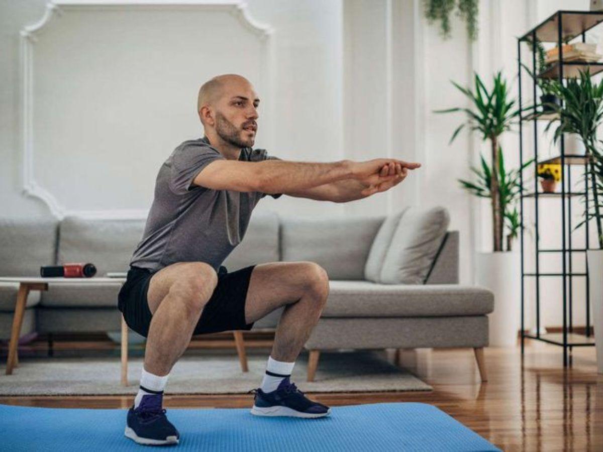 Thực hiện động tác squat sâu để kéo dãn quần jean