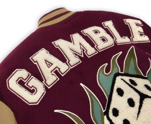 Đặc điểm nhận dạng ấn tượng của những chiếc áo varsity jacket Gamble chính là họa tiết chữ Gamble cách điệu và hình ảnh viên xí ngầu (Nguồn: gambleworldwide.vn)